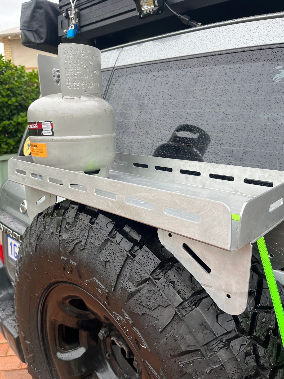 Exterior view of the Nissan Patrol camper conversion and its rear storage setup.