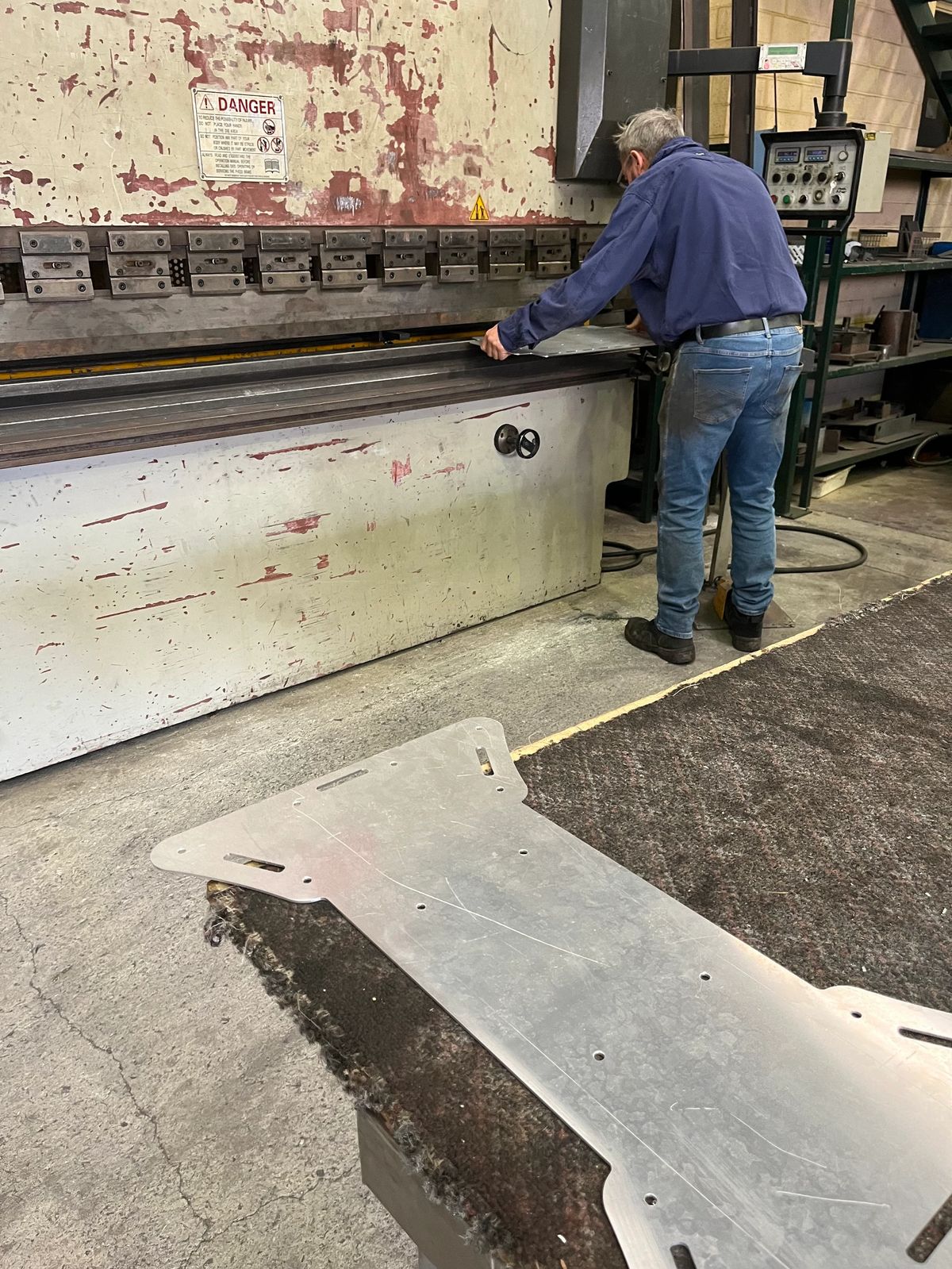 Toby Allen cutting a wooden panel in the workshop.
