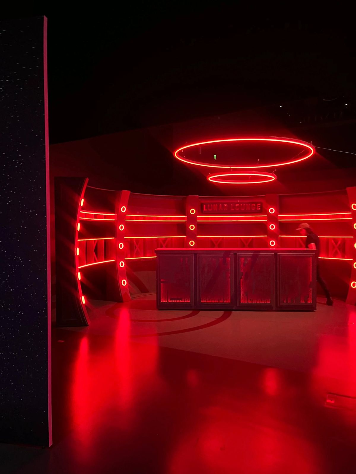 Red-lit To The Moon installation with a circular ceiling feature.